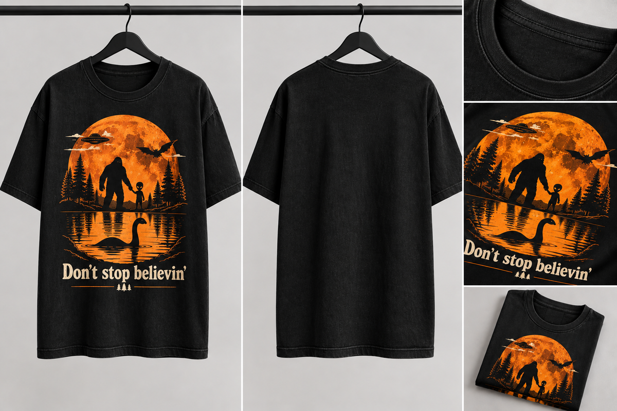 Black short-sleeve graphic T-shirt shown from the front and back, with a large orange Halloween-style print featuring a full moon, silhouettes of trees and a figure, a swan reflection, and the text 'Don't stop believin''.